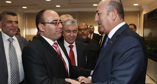 تشاووش أوغلو مصافحاً رئيس بلدية مصراتة خلال زيارته